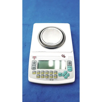White fulcrum torbal drx300 scale balance with circular metal platform and light gray keypad with yellow and teal keys