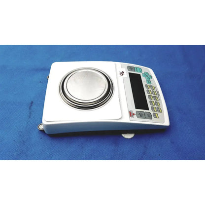 White fulcrum torbal drx300 scale balance with circular metallic platform and keypad featuring green yellow and gray buttons