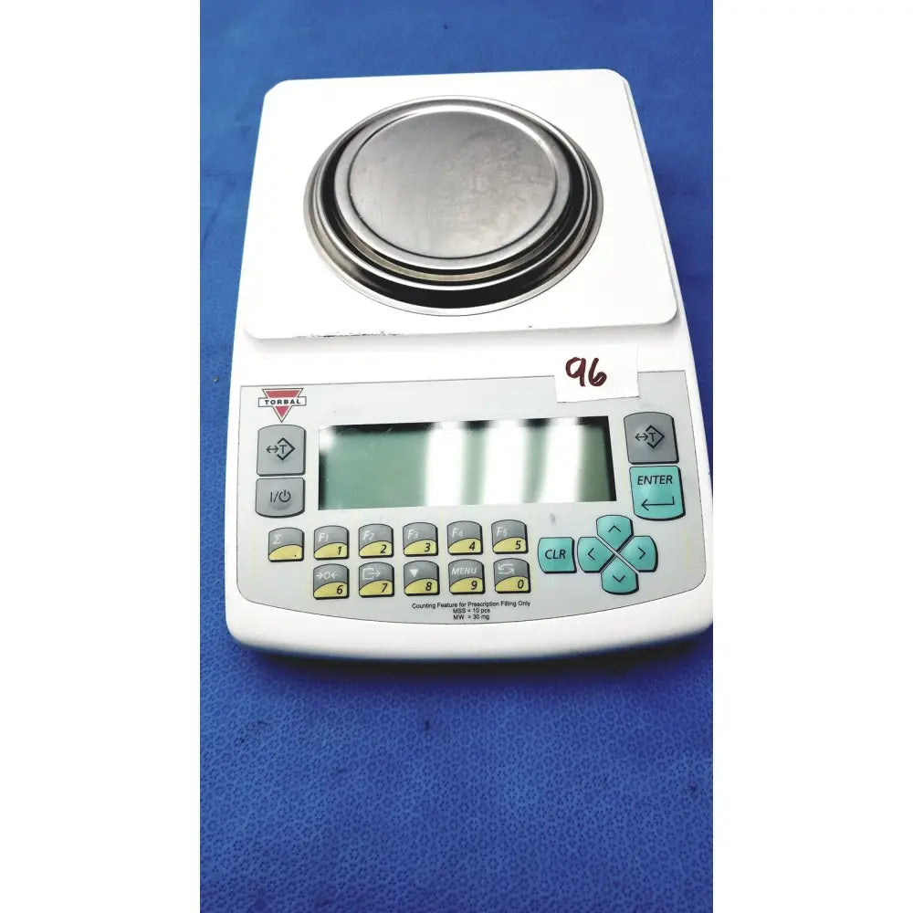 White fulcrum torbal drx300 scale balance with metallic platform and gray panel featuring yellow and teal buttons
