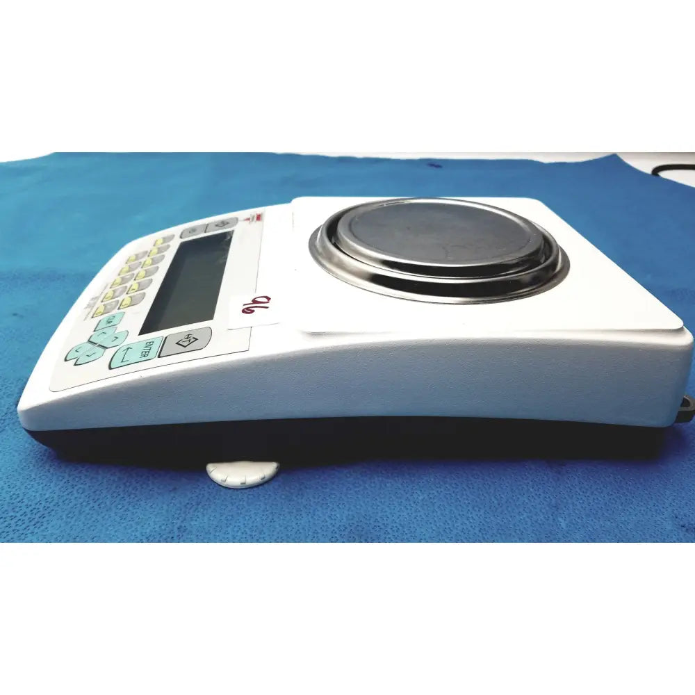 White fulcrum torbal drx300 scale balance with circular metallic platform and light blue function buttons for precise weighing