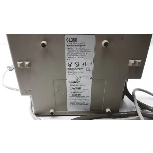 Gray metal Gaymar SPR Plus III medical device labeled cl360 with warning and caution labels visible on the back side