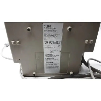 Gray metal Gaymar SPR Plus III medical device labeled cl360 with warning and caution labels visible on the back side