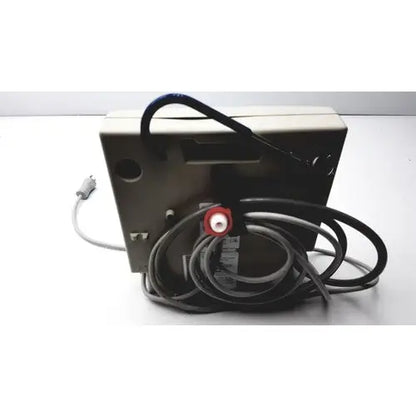 Beige rectangular Gaymar SPR Plus III electronic device with coiled black cables and red circular connector on back side