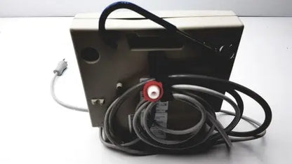 Beige rectangular Gaymar SPR Plus III electronic device with coiled black cables and red circular connector on back side