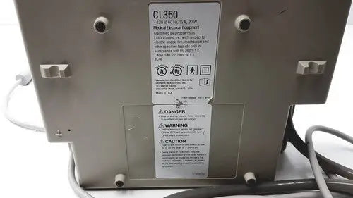 Gray metal Gaymar SPR Plus III medical device labeled cl360 with warning and caution labels visible on the back side