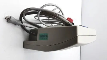 Gray and white wall-mounted Gaymar SPR Plus III power strip with coiled gray cords for medical use