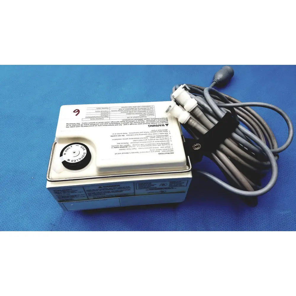 White rectangular Gaymar T Pump heat therapy pump tp500c with black circular dial and coiled gray power cord