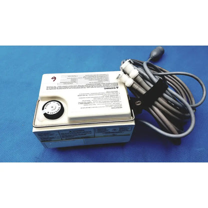 White rectangular Gaymar T Pump heat therapy pump tp500c with black circular dial and coiled gray power cord