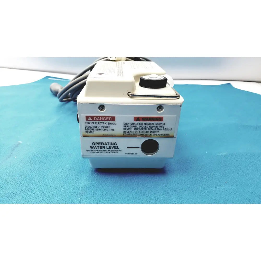 White medical-grade gaymar t pump tp500c with black cap and warning labels for pump heat therapy use