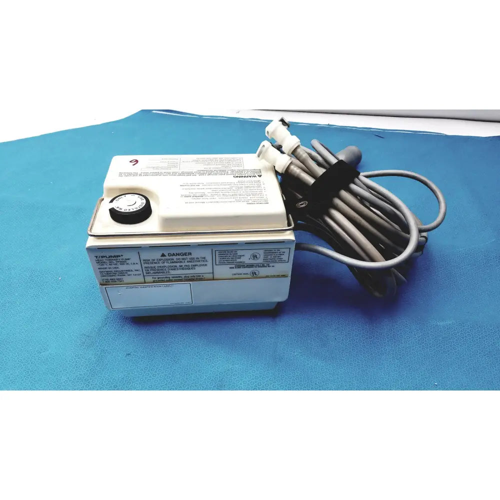 White rectangular tp500c gaymar t pump heat therapy control unit with black rotary dial and coiled gray hoses