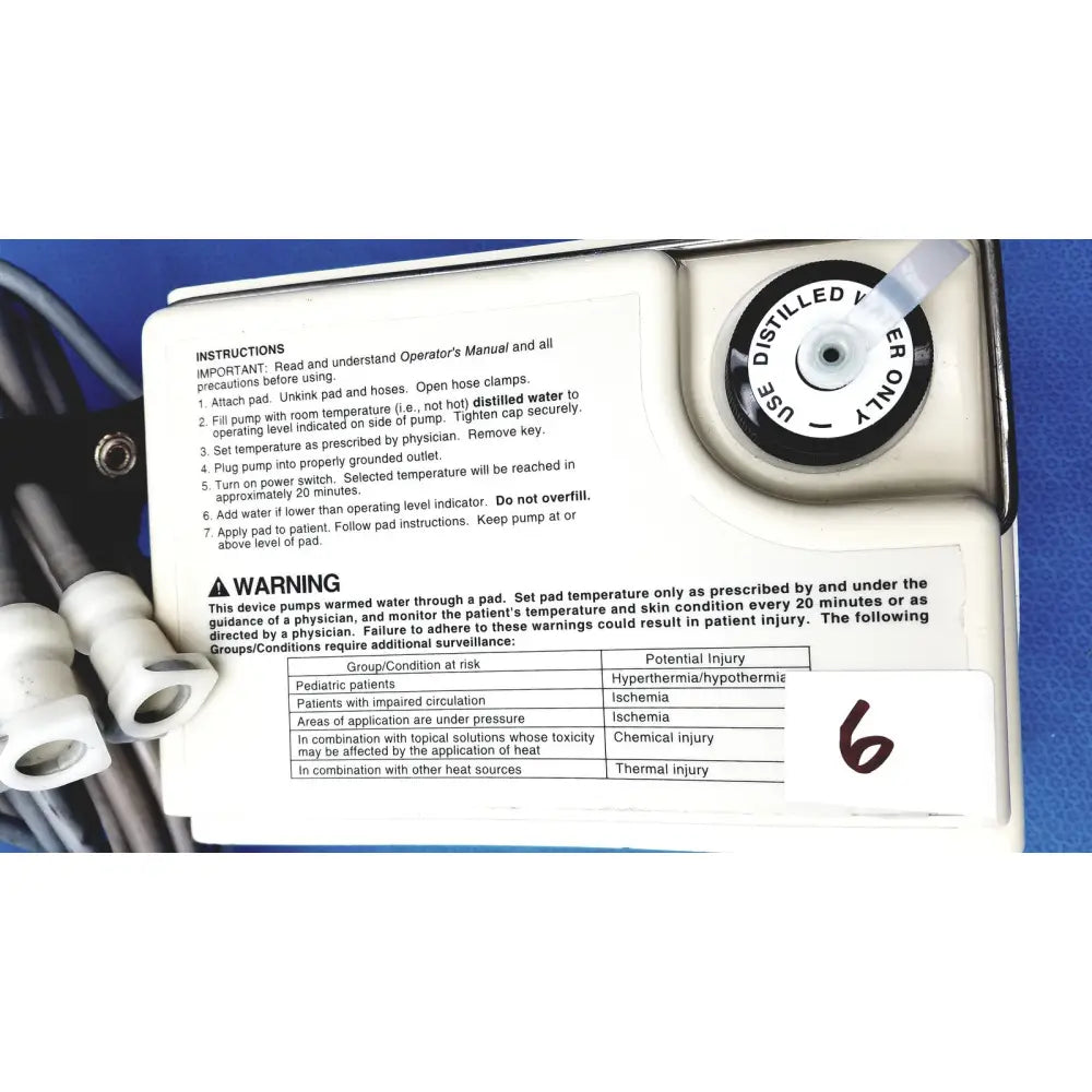 White plastic gaymar t pump tp500c heat therapy pump with black text and circular dial labeled use distilled water only