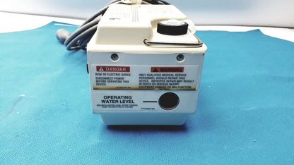 White medical-grade gaymar t pump tp500c with black cap and warning labels for pump heat therapy use
