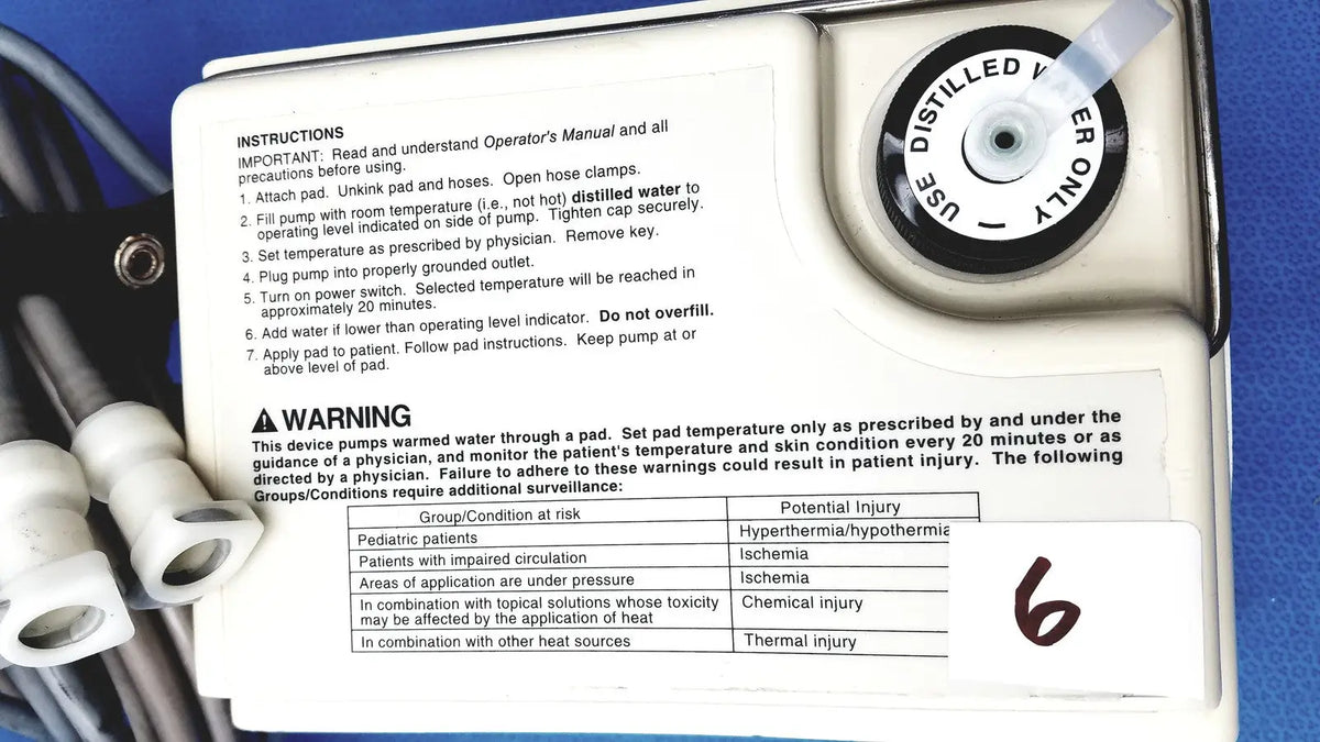 White plastic gaymar t pump tp500c heat therapy pump with black text and circular dial labeled use distilled water only