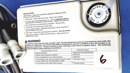 White plastic gaymar t pump tp500c heat therapy pump with black text and circular dial labeled use distilled water only