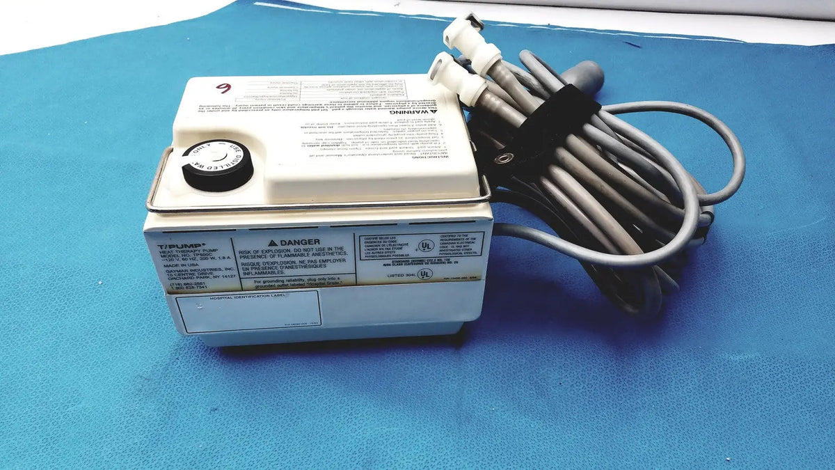 White rectangular tp500c gaymar t pump heat therapy control unit with black rotary dial and coiled gray hoses