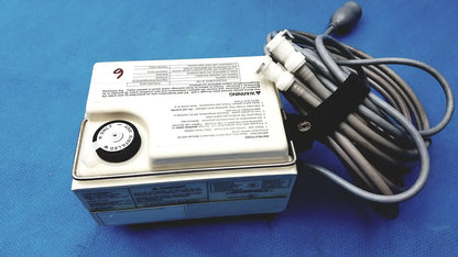 White rectangular Gaymar T Pump heat therapy pump tp500c with black circular dial and coiled gray power cord