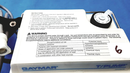 White plastic gaymar t pump tp500c heat therapy pump with black control dial and printed instructions for medical use