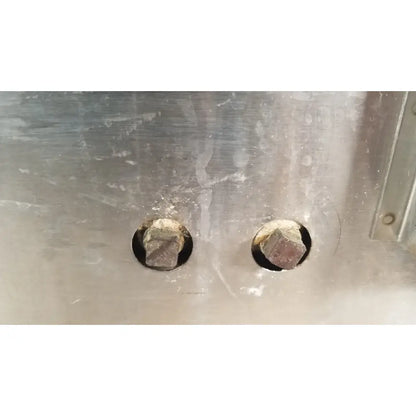 Two hexagonal bolts with a dark finish on a brushed stainless steel panel of gca precision scientific dubnoff metabolic incubator