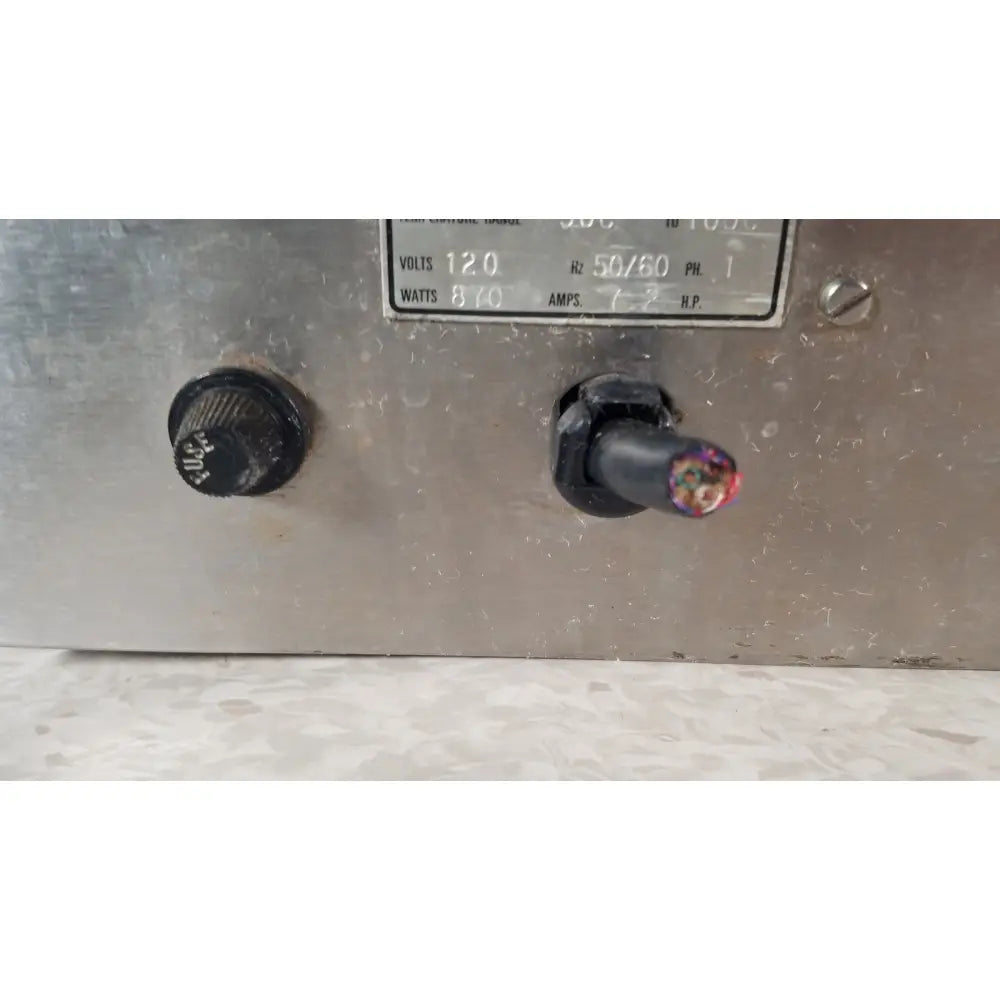 A weathered metallic control panel with a black knob and exposed wiring on the back of gca precision scientific dubnoff metabolic incubator