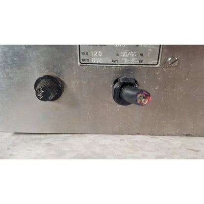 A weathered metallic control panel with a black knob and exposed wiring on the back of gca precision scientific dubnoff metabolic incubator