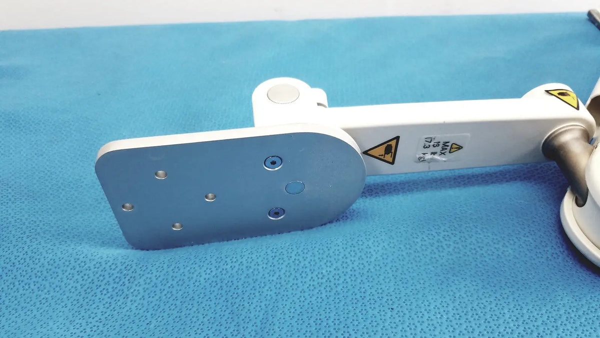 White and silver gcx vhm variable height arm with flat metallic plate featuring six screw holes for secure mounting
