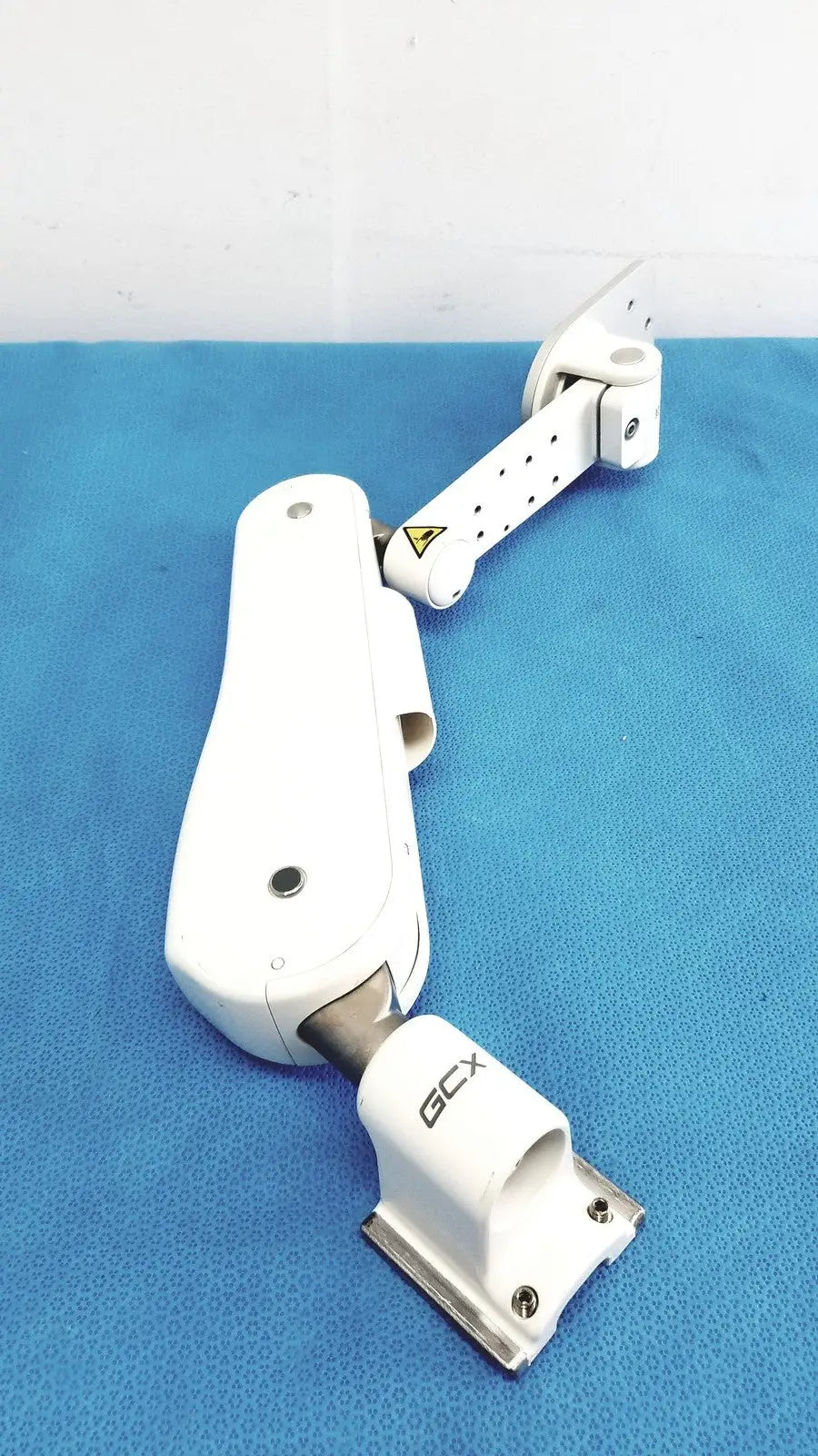 White plastic and metal gcx vhm variable height arm with adjustable monitor support and gcx branding on the base