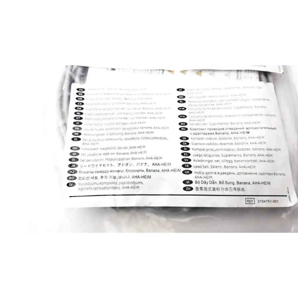 White paper label with multilingual text and reference number on the back of ge 2104751-001 lead wire set add on banana aha heim