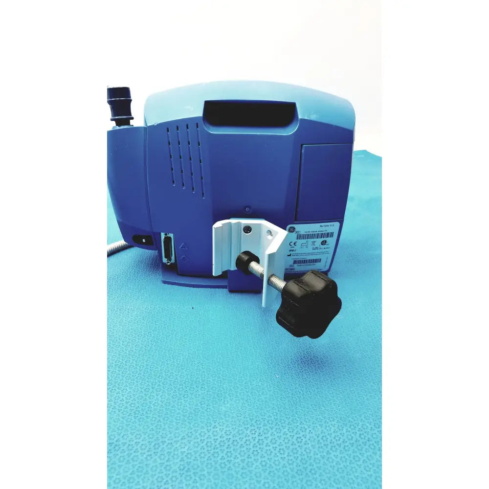 Blue carescape dinamap v100 medical device with white clamp and black adjustment knob for vital signs monitoring