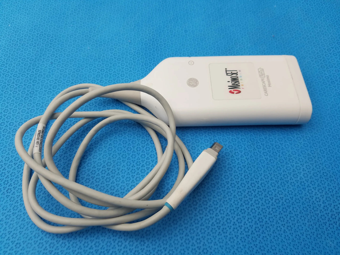 White misonoset ultrasound transducer with coiled gray cable for ge carescape masimo rainbow set pulse co-oximetry parameter