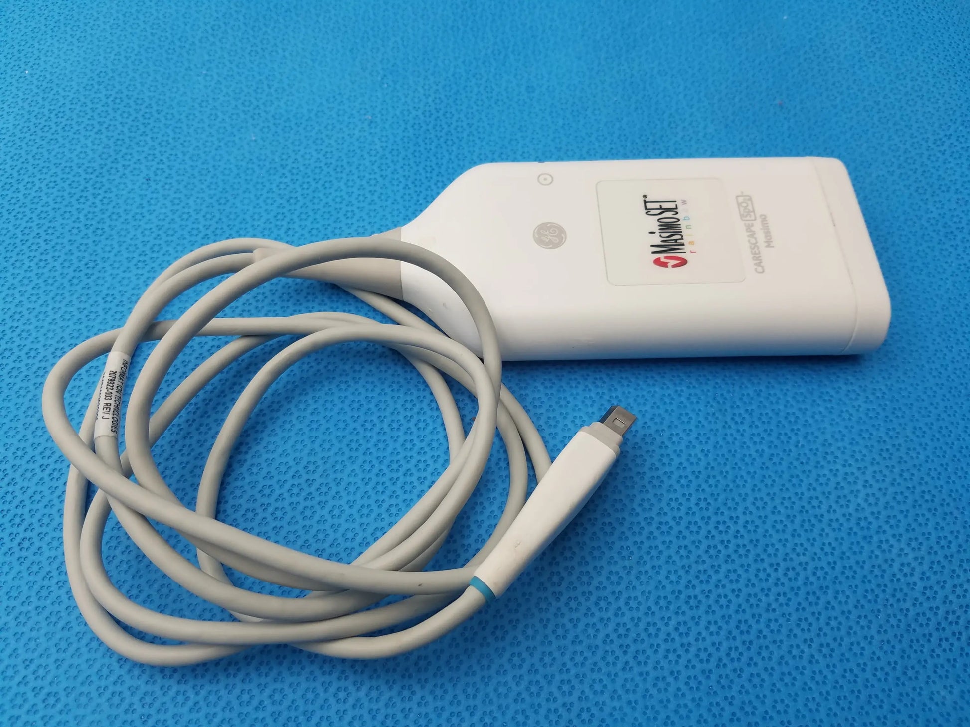 White misonoset ultrasound transducer with coiled gray cable for ge carescape masimo rainbow set pulse co-oximetry parameter