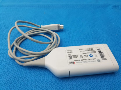White plastic ultrasound transducer with coiled gray cable and metallic connector back labeled ge carefusion for masimo rainbow set