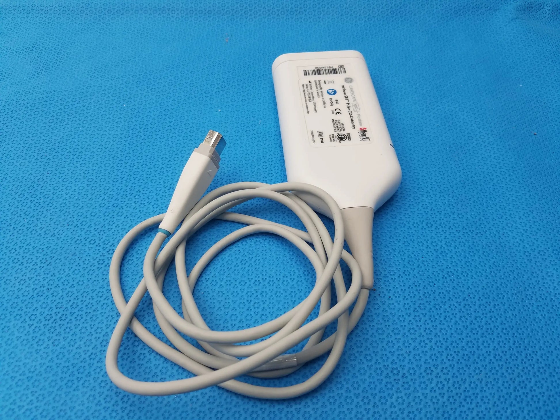 White medical ultrasound transducer with coiled gray cable and metallic connector for GE Carescape masimo rainbow set