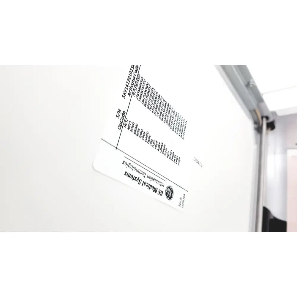 White rectangular label with black text and ge medical systems logo on the back of a ge case stress test cardiac exercise testing unit