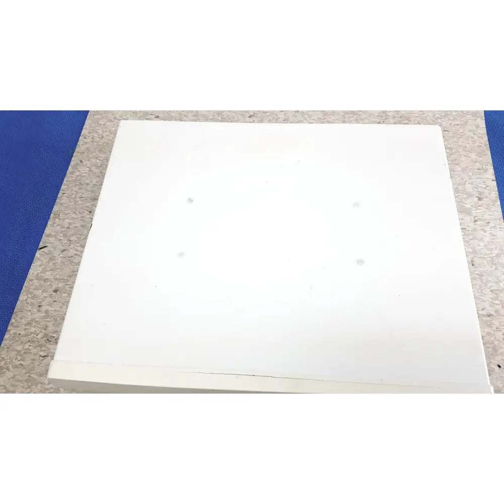 White rectangular board with four circular indentations on the back of the ge cic pro mp100d central station panel