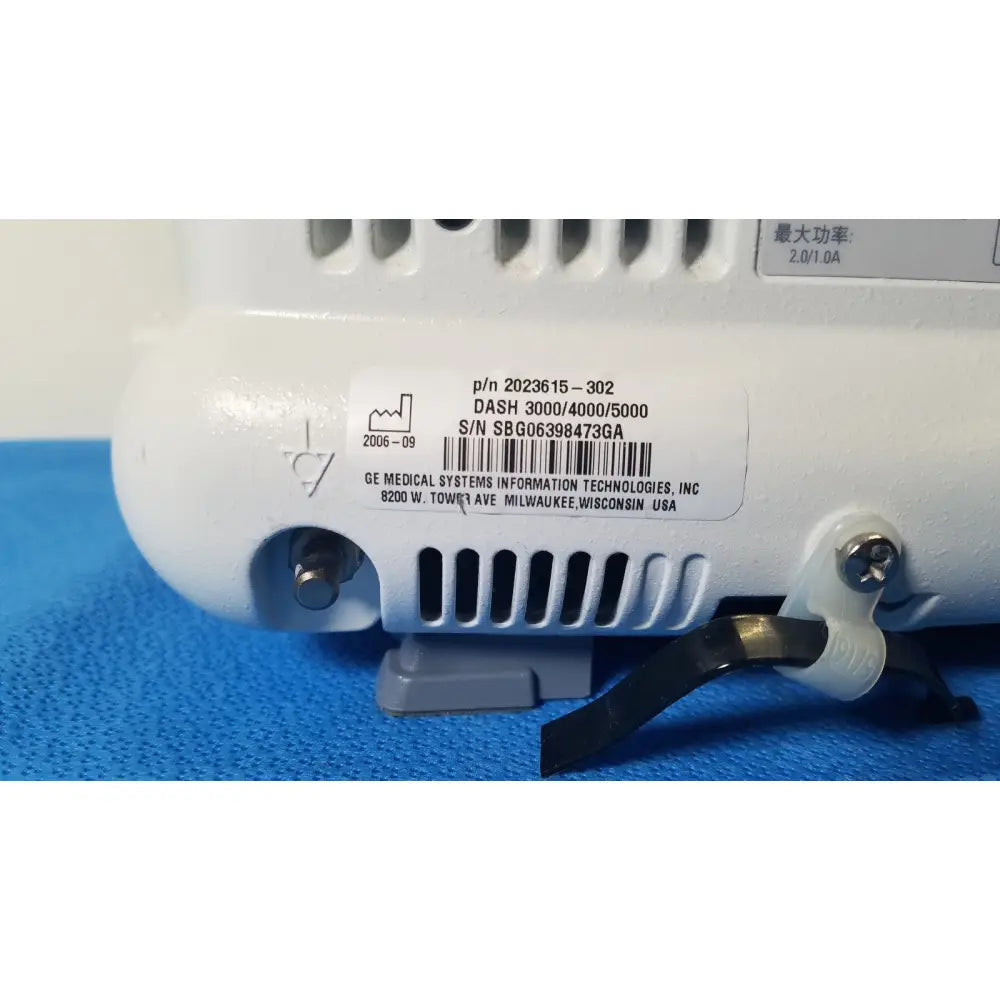 White plastic ge dash 5000 patient monitor ecg with black vented casing and barcode label back side view
