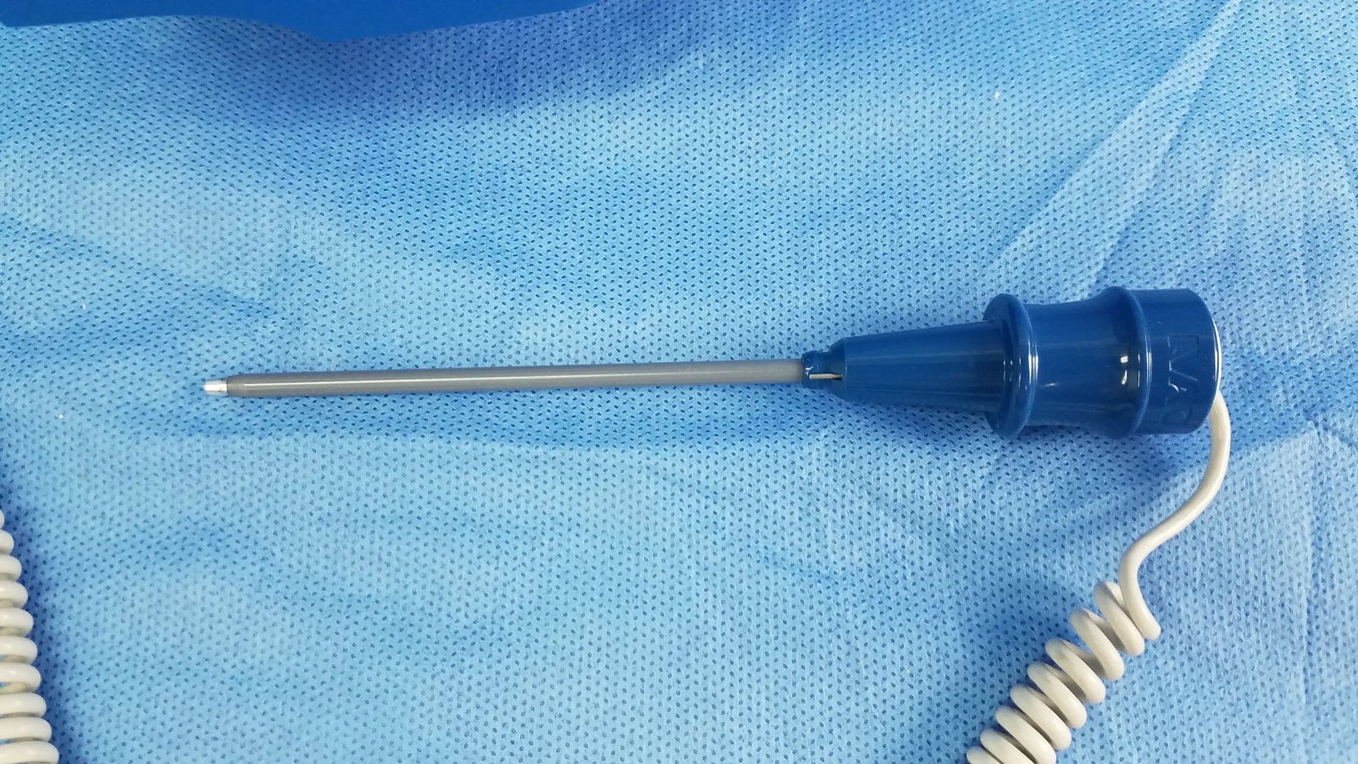 Blue-handled medical probe with metallic shaft and coiled white cable for GE Dinamap vital signs monitor with nibp cuffs and power adapter