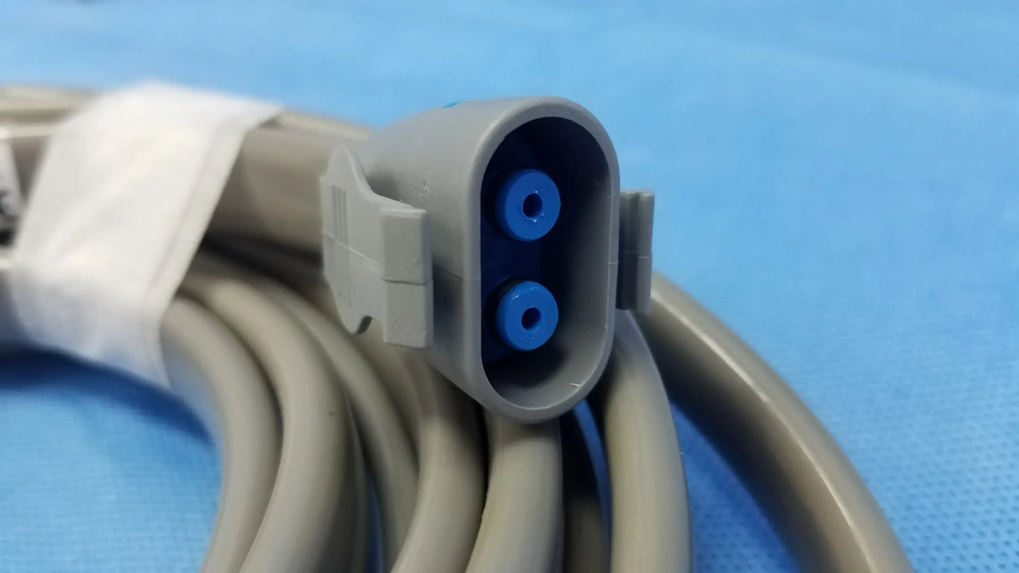 Gray medical cable with gray plastic connector and two blue circular ports for ge dinamap vital signs monitor nibp cuffs and power adapter
