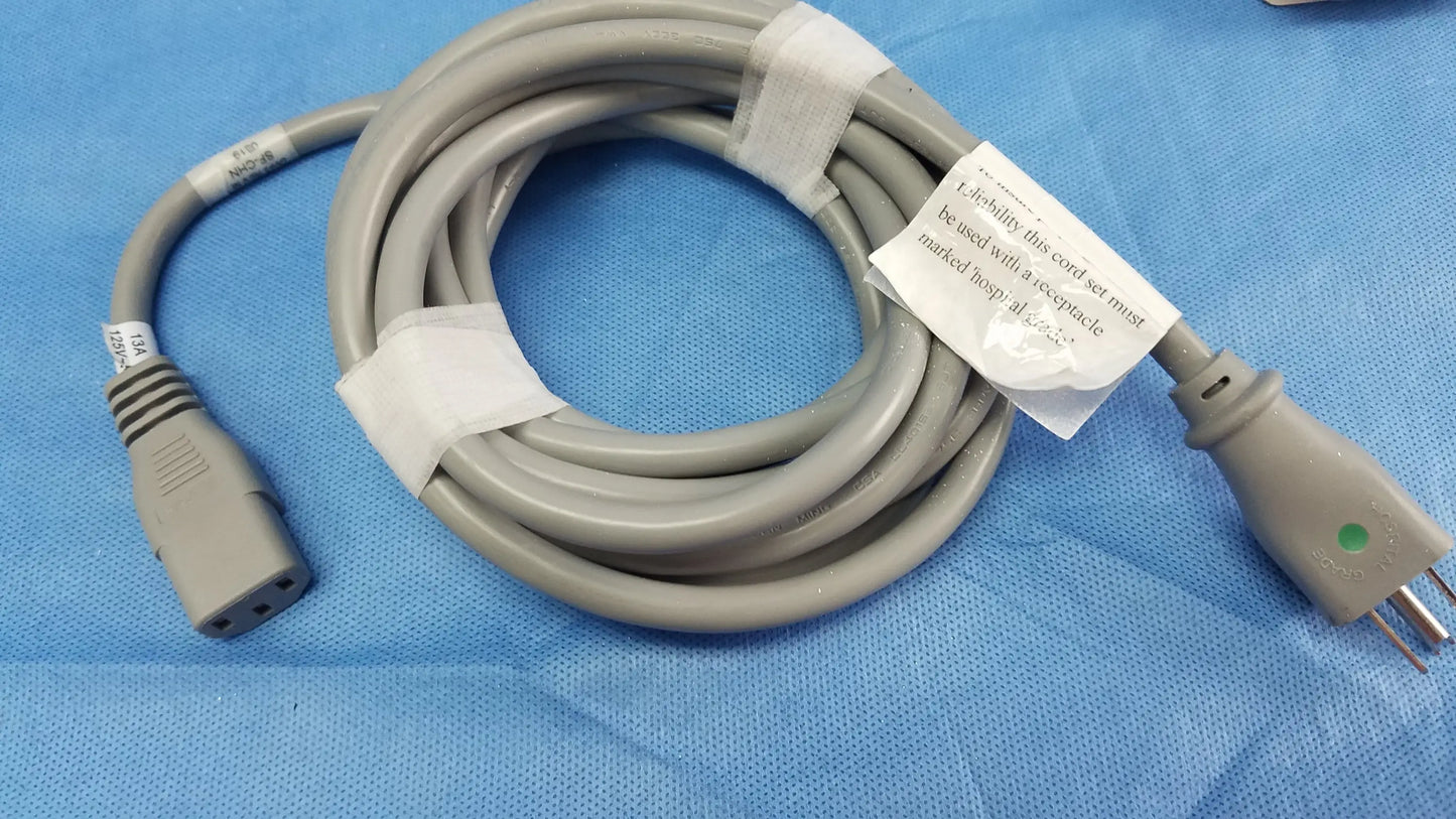 Gray coiled power adapter cord with molded connectors and white tape for ge dinamap v100 vital signs monitor nibp cuffs
