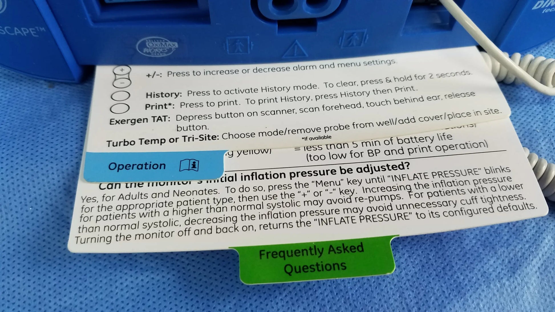 Blue plastic ge dinamap v100 vital signs patient monitor with white coiled cable nibp cuffs and power adapter includes operation card