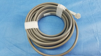 Gray coiled medical cable with white connector and tape securing loops for ge dinamap v100 vital signs monitor accessories including nibp cuffs and power adapter