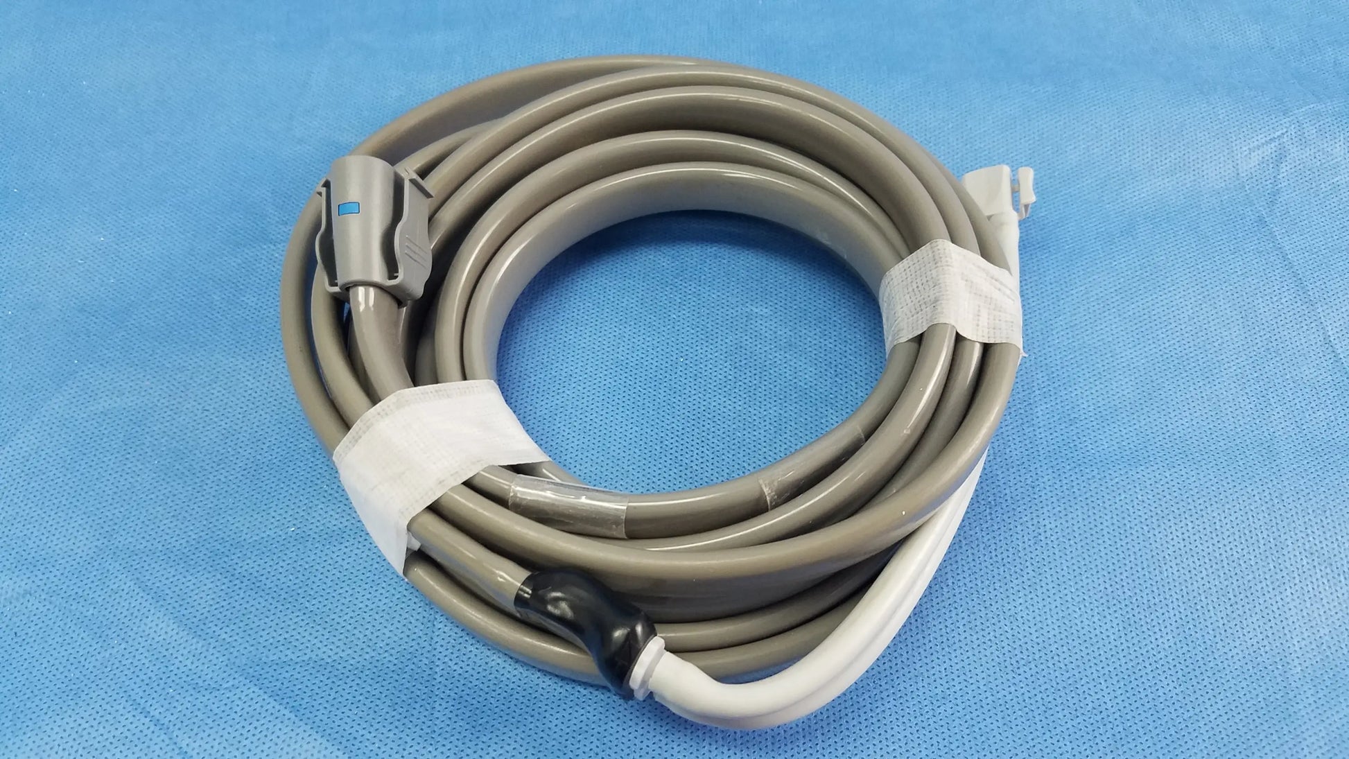 Gray coiled medical cable with gray and white connectors secured by white tape for ge dinamap vital signs monitor with nibp cuffs and power adapter