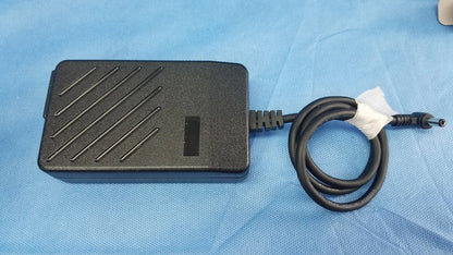 Black rectangular power adapter with diagonal ridges and coiled cable for ge dinamap v100 vital signs monitor with nibp cuffs