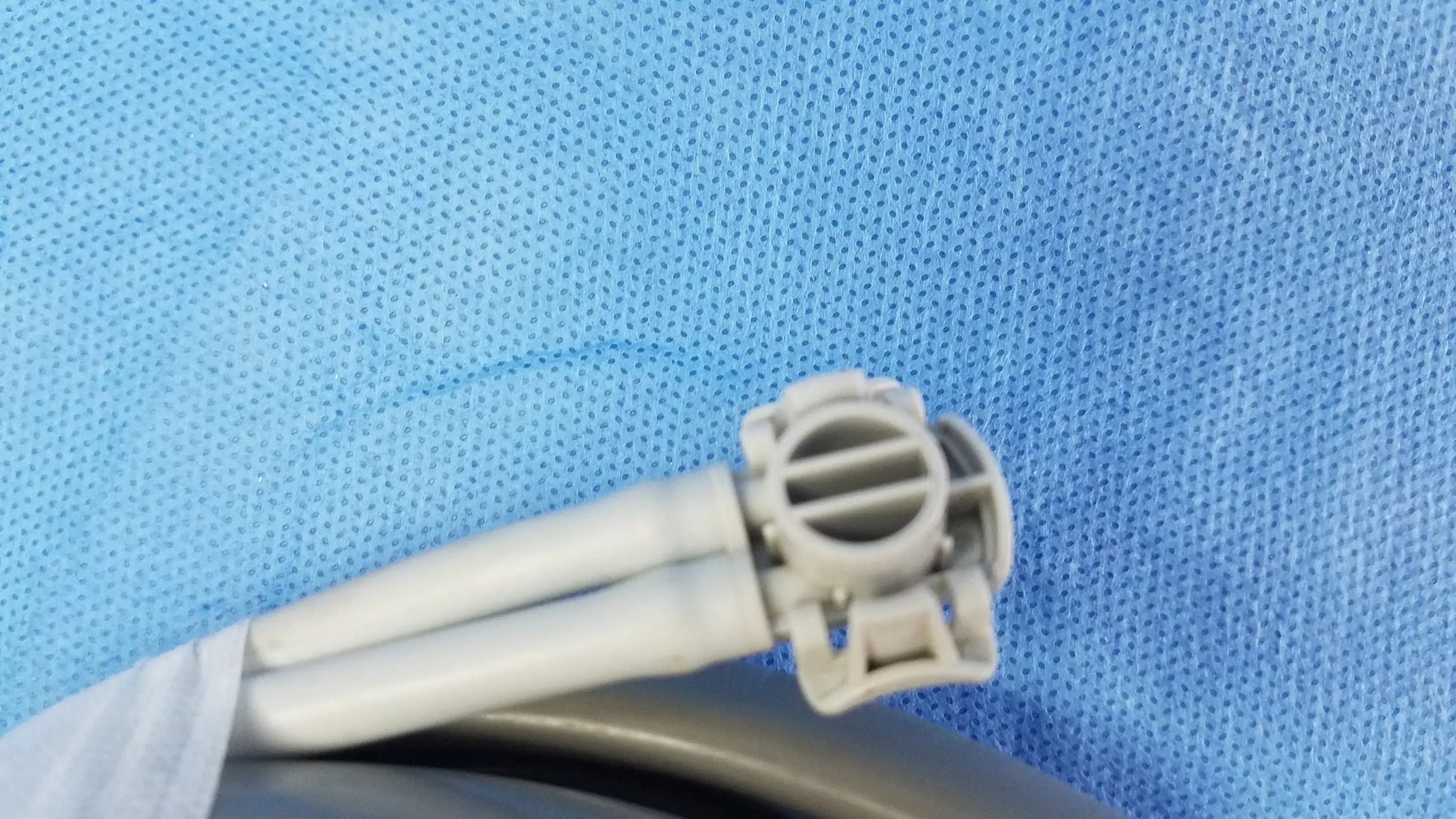 Gray plastic connector with circular ribbed design and two white cables for ge dinamap vital signs monitor power adapter nibp cuffs