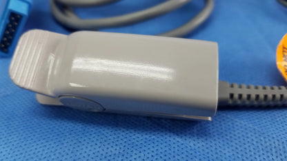 Gray plastic pulse oximeter clip with textured grip and cable for vital signs monitoring in ge dinamap v100 with nibp cuffs and power adapter