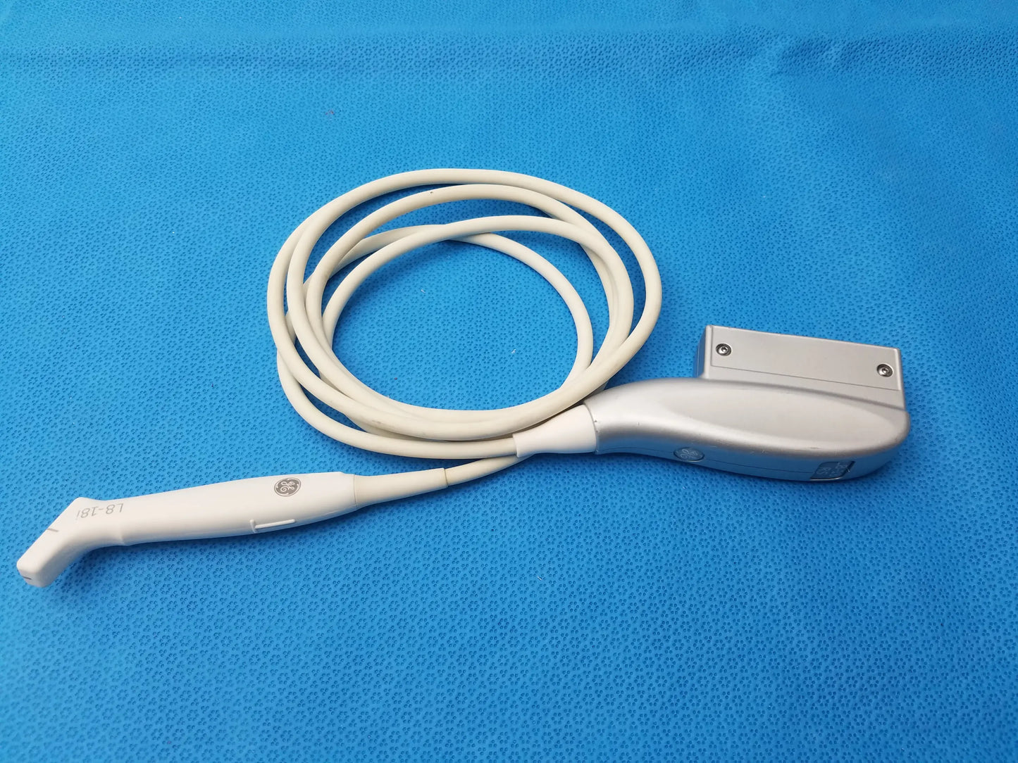White and silver GE Healthcare L8-18i-RS ultrasound transducer probe with coiled cable compatible with ultrasound transducer isl-61 model