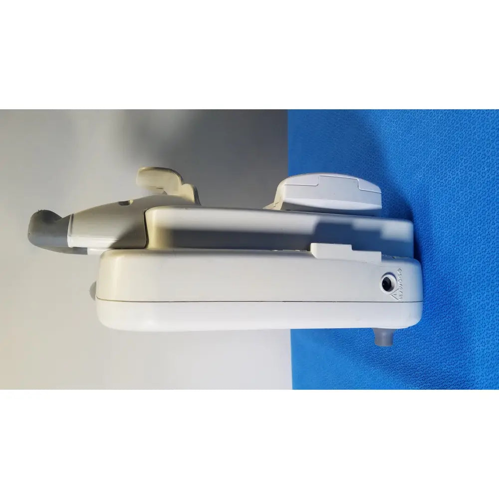 White and gray GE Healthcare Transport Pro patient monitor with sleek ergonomic curved handle and multiple control panels