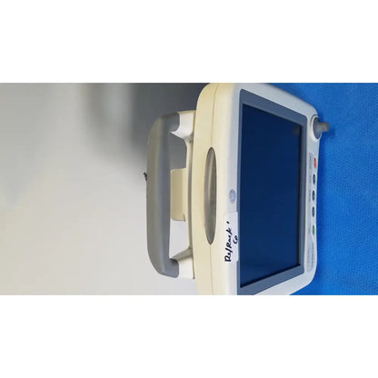 Beige and gray GE healthcare transport pro patient monitor with touchscreen, control buttons, and integrated handle for mobility