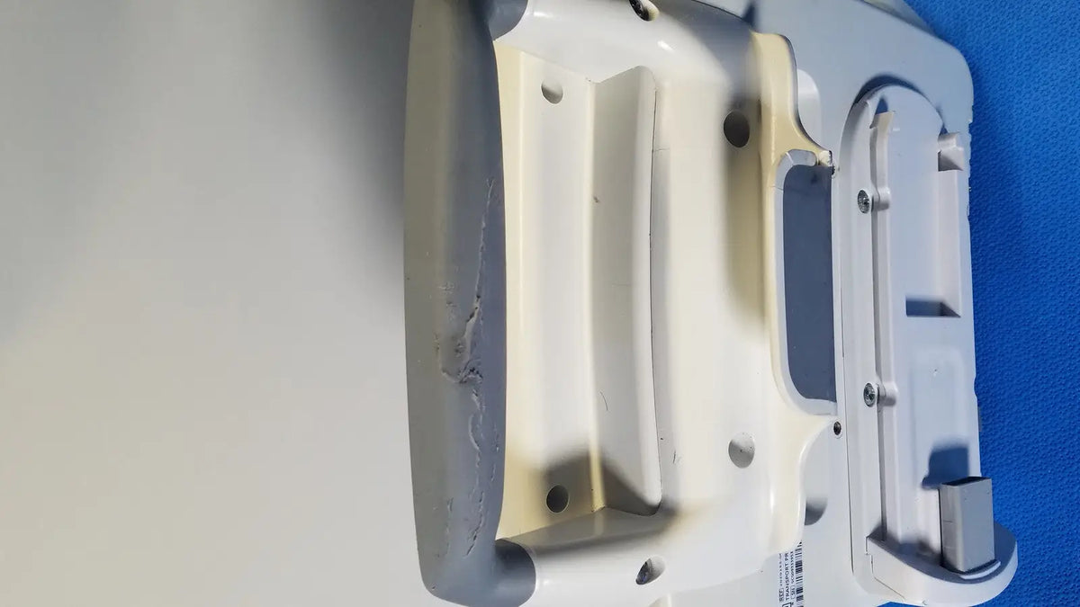 Gray and white plastic healthcare transport pro patient monitor with textured grip and visible screws molded compartments