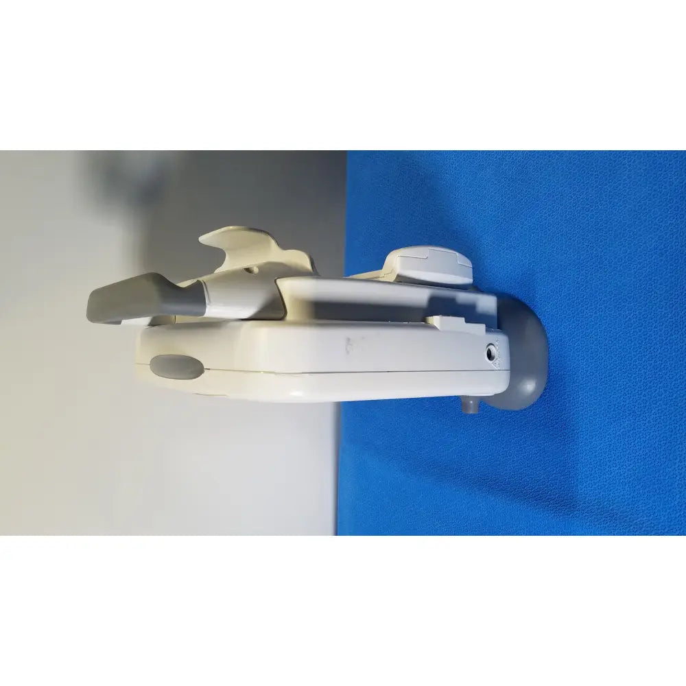 White and gray plastic wall-mounted child safety gate with curved design for ge healthcare transport pro patient monitor
