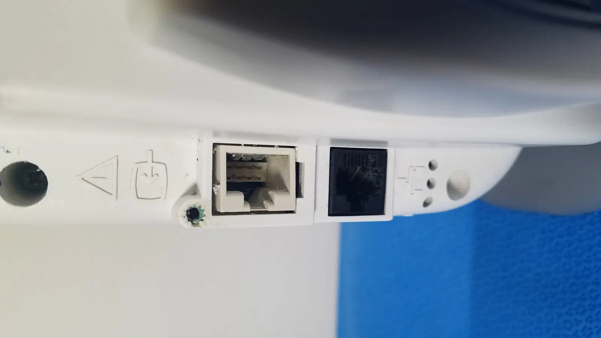 White plastic network port panel with two ethernet ports on the back of ge healthcare transport pro patient monitor